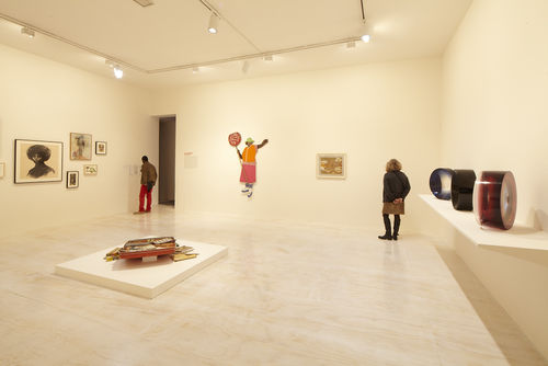 Foreground: Dan Concholar, "Suitcase," c. 1980; left wall: works by Elizabeth Leigh-Taylor, David Hammons, and Suzanne Jackson; back wall: Marie Johnson Calloway, "School Crossing Guard," 1970s and Alonzo Davis, "Untitled," 1978–79; right wall: three works by Fred Eversley. Installation view at MoMA PS1, Long Island City, NY