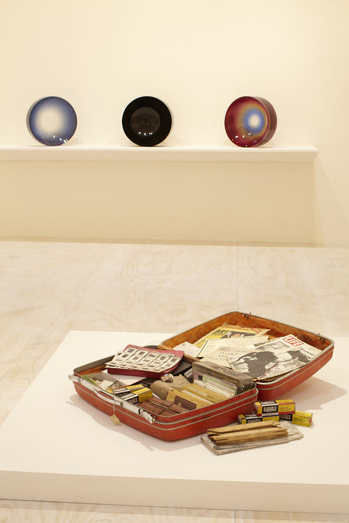 Foreground: Dan Concholar, "Suitcase,"c. 1980; background: three works by Fred Eversley. Installation view at MoMA PS1, Long Island City, NY