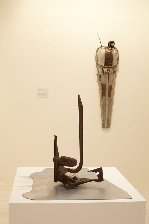 Foreground: Mark di Suvero, "Untitled," c. 1965; background: John Outterbridge, "Urban Man," from the Ethnic Heritage Group, 1981. Installation view at MoMA PS1, Long Island City, NY