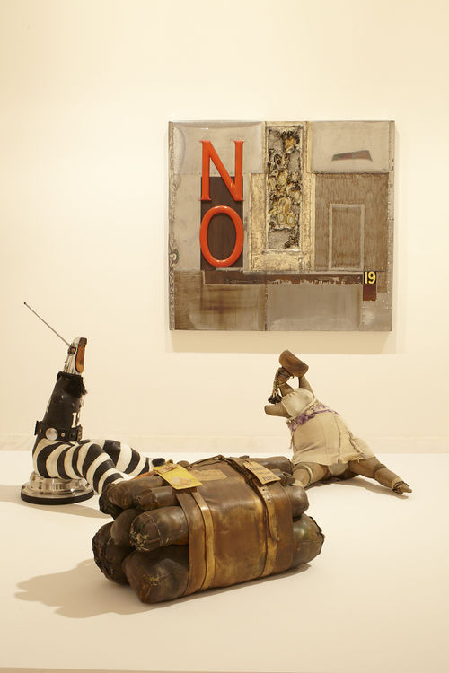 Foreground: three works by John Outterbridge, from left to right: "Captive Image #4," from the Ethnic Heritage Group, c. 1974–76, "Case in Point," from the Rag Man Series, c. 1970, and "Untitled," c. 1974–76; background: Outterbridge, "No Time for Jivin'," from the Containment Series, 1969. Installation view at MoMA PS1, Long Island City, NY