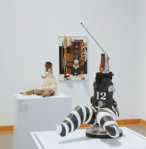 Foreground: John Outterbridge, "Captive Image #4,"from the Ethnic Heritage Group, c. 1974–76 and "Untitled," c. 1974–76; on wall: Noah Purifoy, "Zulu #4," n.d. Installation view at Williams College Museum of Art, Williamstown, MA