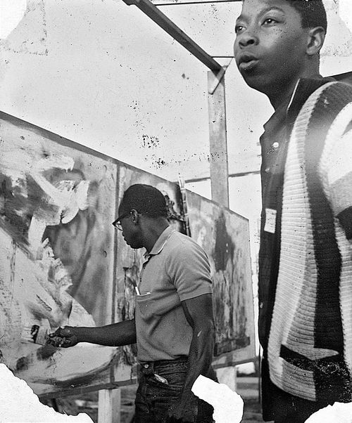 Noah Purifoy making artwork with students