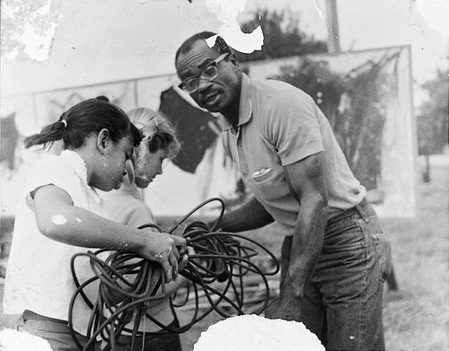Noah Purifoy making artwork with students