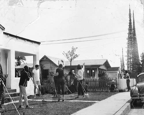 Young people at Watts Towers Arts Center on 107th Street, waving
