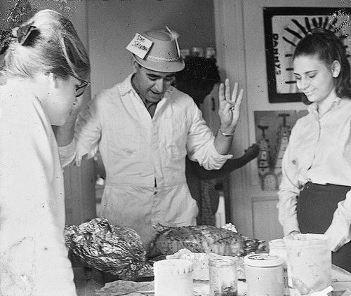 Group looking at food at Watts Towers Arts Center during "Operation Teacup,"an Easter week cleanup organized by the Student Committee for Improvement in Watts, April 1965