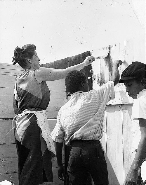 Group painting a gate during "Operation Teacup," an Easter week cleanup organized by the Student Committee for Improvement in Watts, April 1965