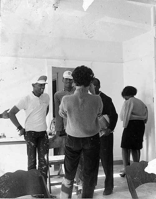 Group inside the Watts Towers Arts Center preparing plans to paint the interior during "Operation Teacup," an Easter week cleanup organized by the Student Committee for Improvement in Watts, April 1965