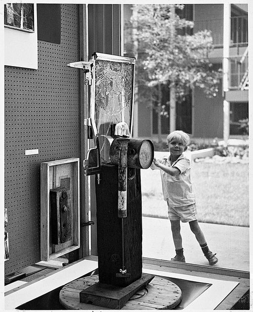 Young boy with works from "66 Signs of Neon" exhibition at University of California, Los Angeles, c. 1966