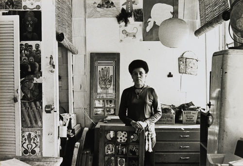 Betye Saar in her Los Angeles studio, 1970. "View from the Palmist Window," 1966, is behind her at left; she is holding "Black Girl's Window," 1969.