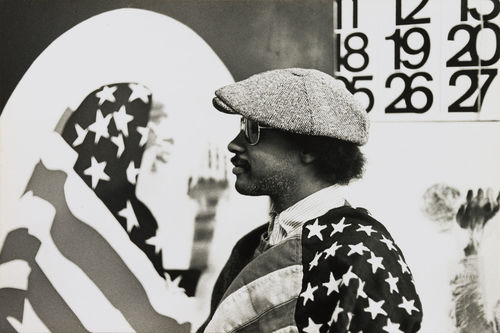 David Hammons in his Los Angeles studio, 1970. "Pray for America," 1969, is shown at left and a portion of "Wine Leading the Wine," c. 1969, is visible at right