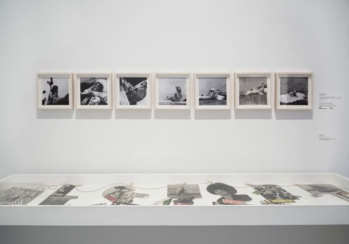 The Power of Words gallery. On wall: Marta Minujín, Leyendo las noticias (Reading the News), 1965; in vitrine: Neide Sá, A Corda (The rope), 1967. Installation view at Brooklyn Museum, New York
