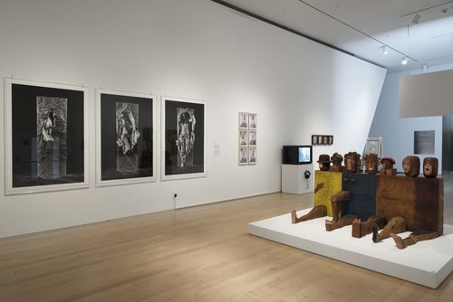 Self-Portrait gallery. Left, on wall: Lourdes Grobet, Hora y media (Hour and a half), 1975; right, on floor: Marisol, Self-Portrait, 1961–62. Installation view at Brooklyn Museum, New York
