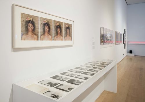 Self-Portrait gallery. Foreground, on wall: Sylvia Salazar Simpson, Antes-Después (Before-After), 1981; in vitrine: Sylvia Salazar Simpson, Sylvia Salazar Simpson, 1970s. Installation view at Brooklyn Museum, New York
