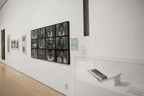 Social Places gallery. Center: Claudia Andujar, works from the series Marcados (Marked), 1981–83; in vitrine: Alicia d'Amico and Sara Facio, Humanario, 1976. Installation view at Brooklyn Museum, New York
