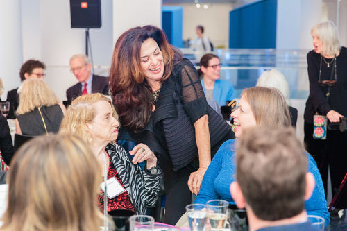 Artists Anna Bella Geiger (left, seated) and Analívia Cordeiro (center, standing) at the luncheon reception honoring Radical Women. Brooklyn Museum, April 12, 2018
