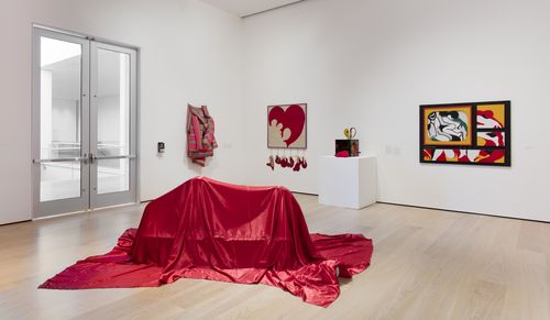 The Erotic gallery. On floor: Feliza Bursztyn, Cama (Bed), 1974; background, from left to right: Marta Minujín, Colchón (Mattress), 1964/1985, Delia Cancela, Corazón destrozado (Destroyed Heart), 1964, and Teresinha Soares, Caixa de fazer amor (Lovemaking Box), 1967, and Muera usando las legítimas alpargatas (Die wearing the legitimate espadrilles), 1968. Installation view at the Hammer Museum, Los Angeles