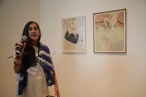 Artist Karen Lamassonne in front of two watercolors from the series Baños (Bathrooms) at the Radical Women artists' walkthrough. Hammer Museum, Los Angeles, September 16, 2017
