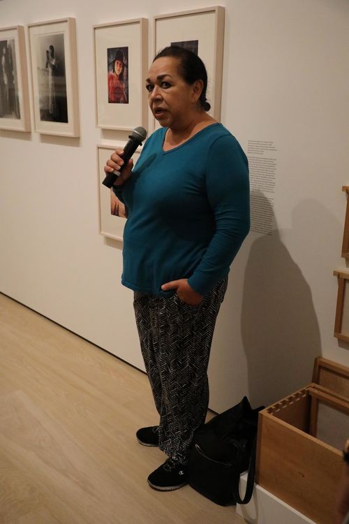 Artist Isabel Castro in front of photographs from the series Women Under Fire at the Radical Women artists' walkthrough. Hammer Museum, Los Angeles, September 16, 2017

