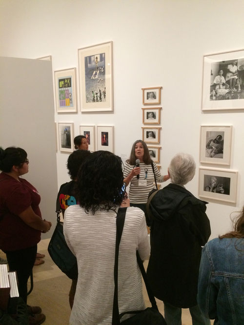 Artist Lourdes Grobet (center, holding microphone) in front of her photographs at the Radical Women artists' walkthrough. Hammer Museum, Los Angeles