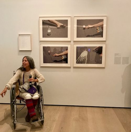Artist Cecilia Vicuña in front of Vaso de leche, Bogotá (Glass of milk, Bogotá), 1979, at the Radical Women artists' walkthrough. Hammer Museum, Los Angeles