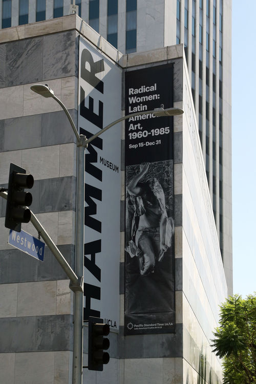 Photograph of Radical Women building banner sign, featuring Lourdes Grobet, Hora y media (Hour and a half), 1975. Hammer Museum, Los Angeles