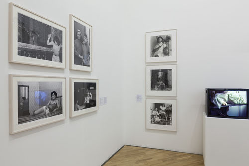 Lugares sociais (Social Places) gallery. From left to right:  Paz Errázuriz, four photographs from the series La manzana de Adán (Adam's Apple), three photographs by Sandra Eleta, and Letícia Parente, Tarefa 1 (Chore 1), 1982. Installation view at Pinacoteca de São Paulo
