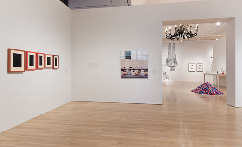 Left wall: Allan McCollum, "Collection of Five Plaster Surrogates," 1982/1990; center: Louise Lawler, "Bulbs," 2005–6; next gallery: works by Rirkrit Tiravanija, Glenn Ligon, Fred Wilson, and Felix Gonzalez-Torres. Installation view at the Hammer Museum, Los Angeles