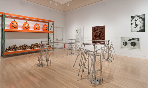 Foreground: Cady Noland, "Frame Device," 1989; left wall: Haim Steinbach, "Backyard Story," 1997; right wall, from left to right: wall text from Andrea Fraser, "Notes on the Margin," 1990/2013, Sue Williams, "Spiritual America," 1992, John Miller, "Untitled," 1990, and Zoe Leonard, "Trophies," 1990. Installation view at the Hammer Museum, Los Angeles