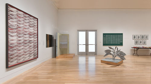 On floor: Tom Burr, "Silver Plant Platform," 1997; left wall, from left to right: Mary Kelly, "Mimus, Act II (Meyers)," 2012, and Tom Burr, "Single Partition Platform," 1997; rear wall, from left to right: Nayland Blake, "Scum," 1990 and Mike Kelley, "Craft Morphology Flow Chart," 1991. Installation view at the Hammer Museum, Los Angeles
