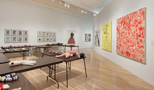 Foreground: Mike Kelley, "Craft Morphology Flow Chart," 1991; left wall, from left to right: Fred Wilson, "Slit," 1995, and three works by Paul McCarthy: "Subjective Subliminal Ads," 1976–1979, "Winston Longs (collage)," 1976–79, and "The Dickies," 1976–79; right wall, from left to right: three paintings by Sue Williams: "The Art World Can Suck My Proverbial Dick," 1992, "Scooter," 1992, "Record Profits," 2008. Installation view at the Hammer Museum, Los Angeles