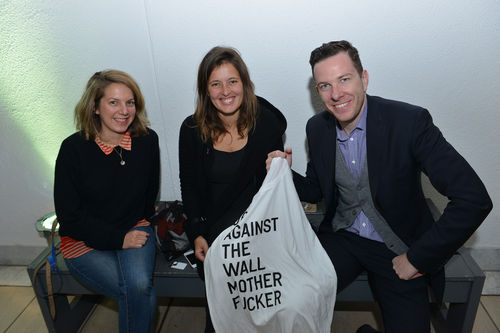 Guests display a t-shirt from Rirkrit Tiravanija, "untitled 2014 (up against the wall motherfucker)," 2014, during the opening of "Take It or Leave It," Hammer Museum, Los Angeles, February 8, 2014