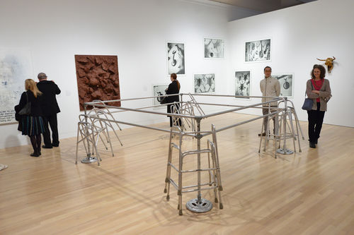 Guests in gallery with Cady Noland, "Frame Device," 1989, works by Sue Williams, John Miller, Zoe Leonard, and Sherrie Levine during the opening of "Take It or Leave It," Hammer Museum, Los Angeles, February 8, 2014