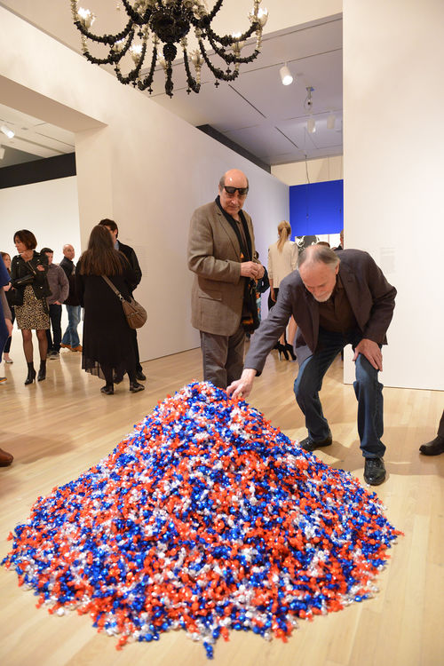 A guest reaches for a candy from Felix Gonzalez-Torres, "Untitled (USA Today)," 1990. Hammer Museum, Los Angeles