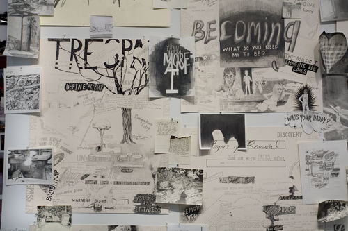 Graphite drawings cover a gallery wall