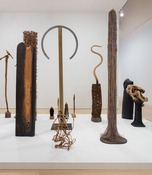 A number of tall wood sculptures