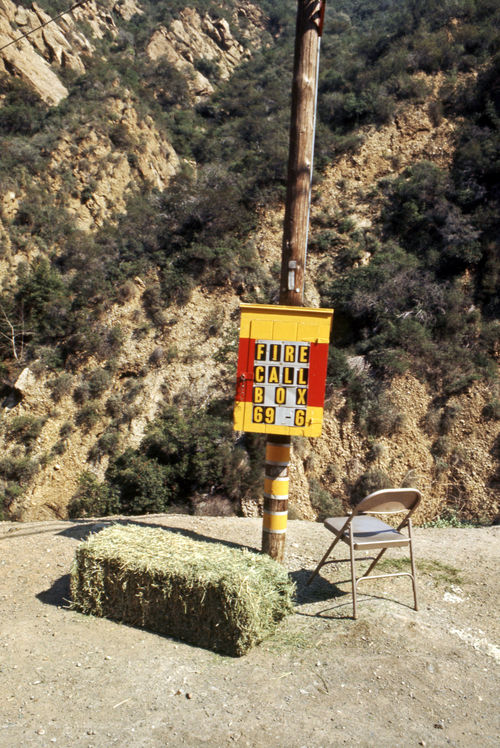 Allen Ruppersberg, Untitled, 1967. Site-specific installation with found utility box, hay bale, and metal folding chair, Pacific Coast Highway, California (destroyed). Courtesy the artist.