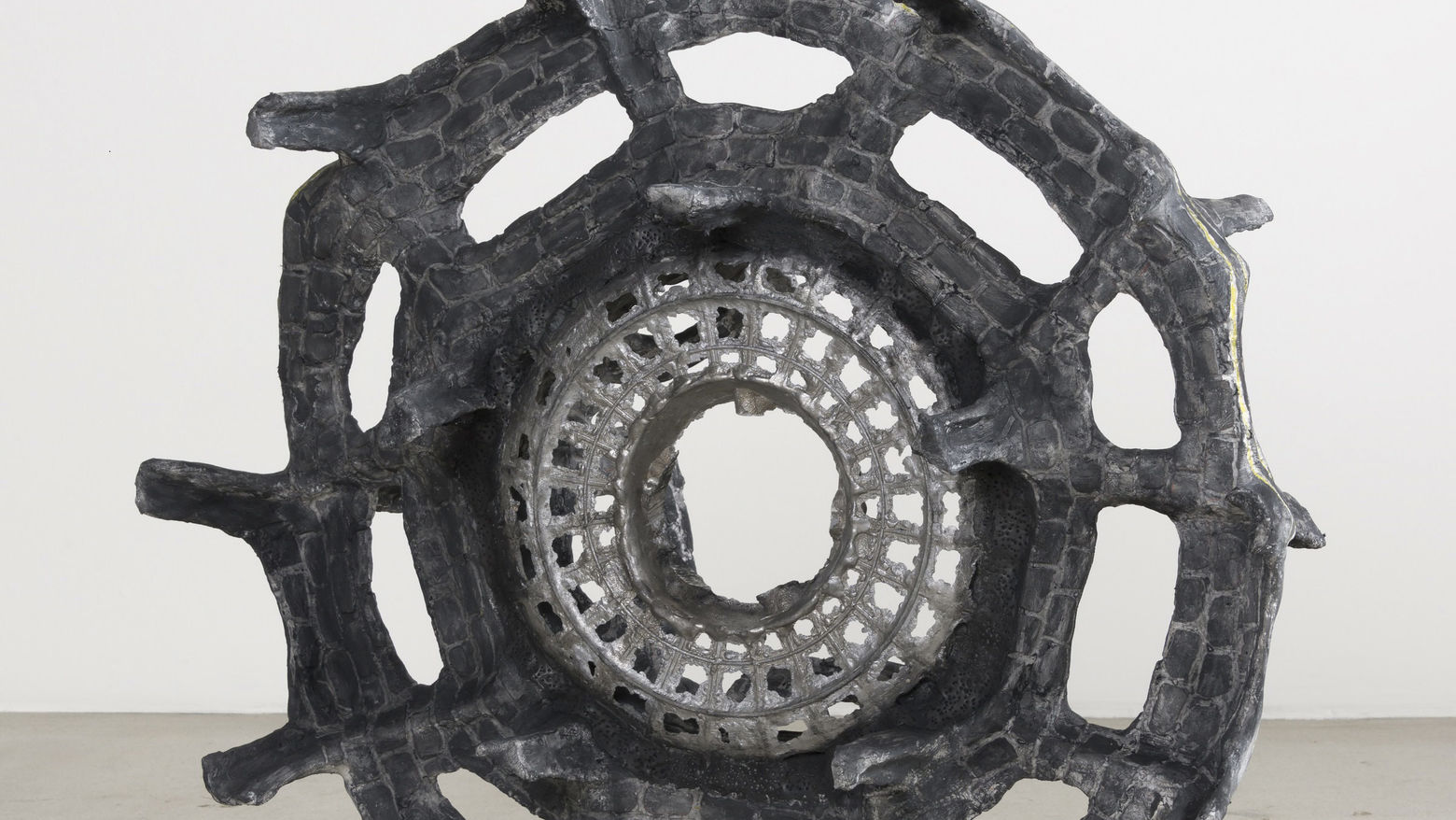 A large wheel made of plastic chairs
