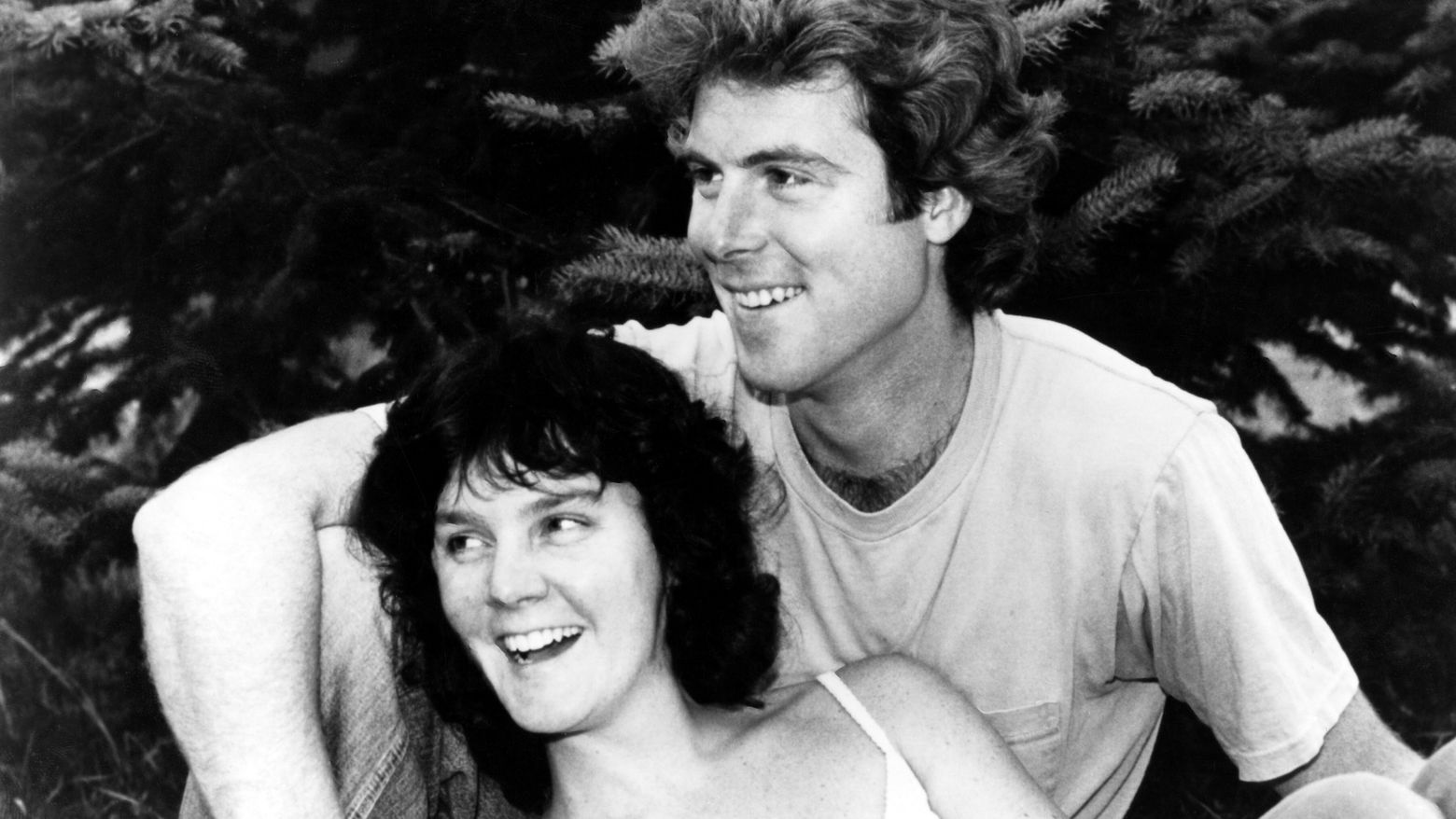Still from the film Return of the Secaucus Seven (1979) showing a woman leaning against a man, both seated and smiling
