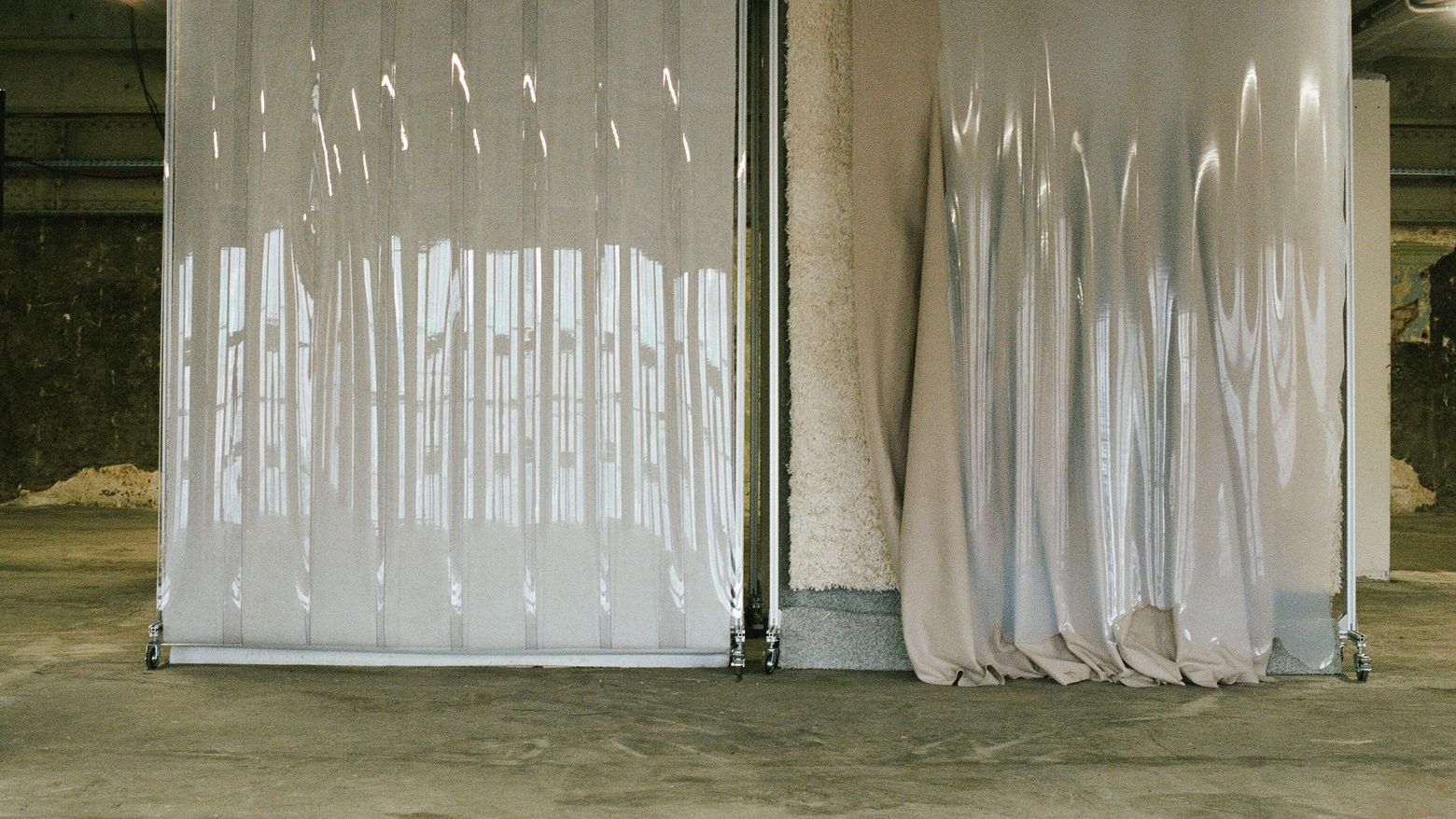 Two plastic curtains hang from standing racks
