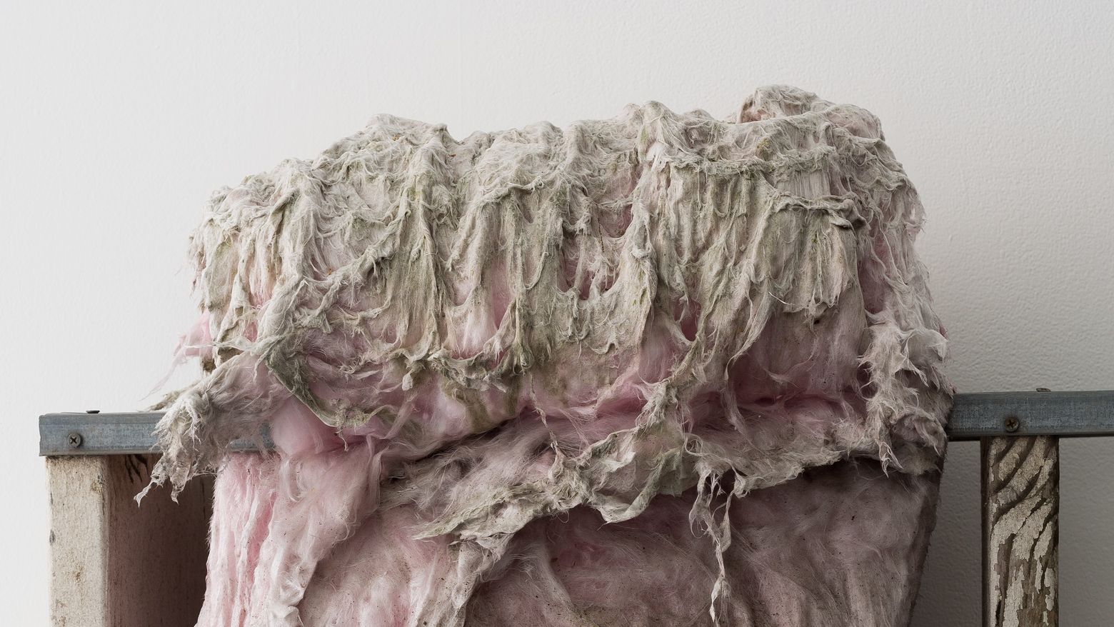A mass of foam hanging from a shelf