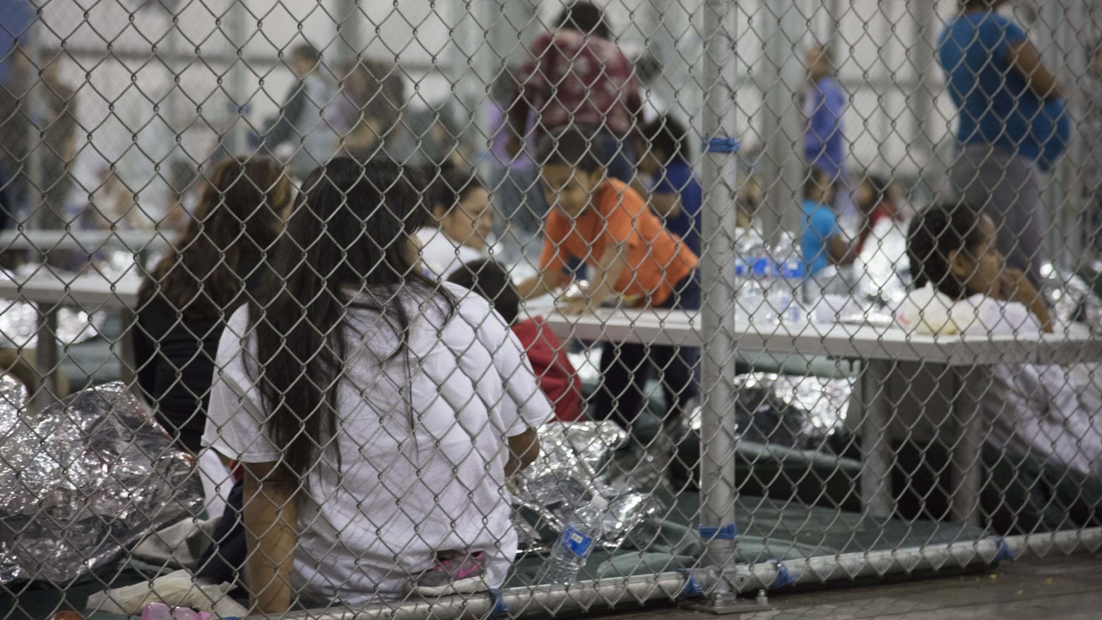 Women detained in a fenced in area at the Central Processing Center in McAllen, Texas, Sunday, June 17, 2018.