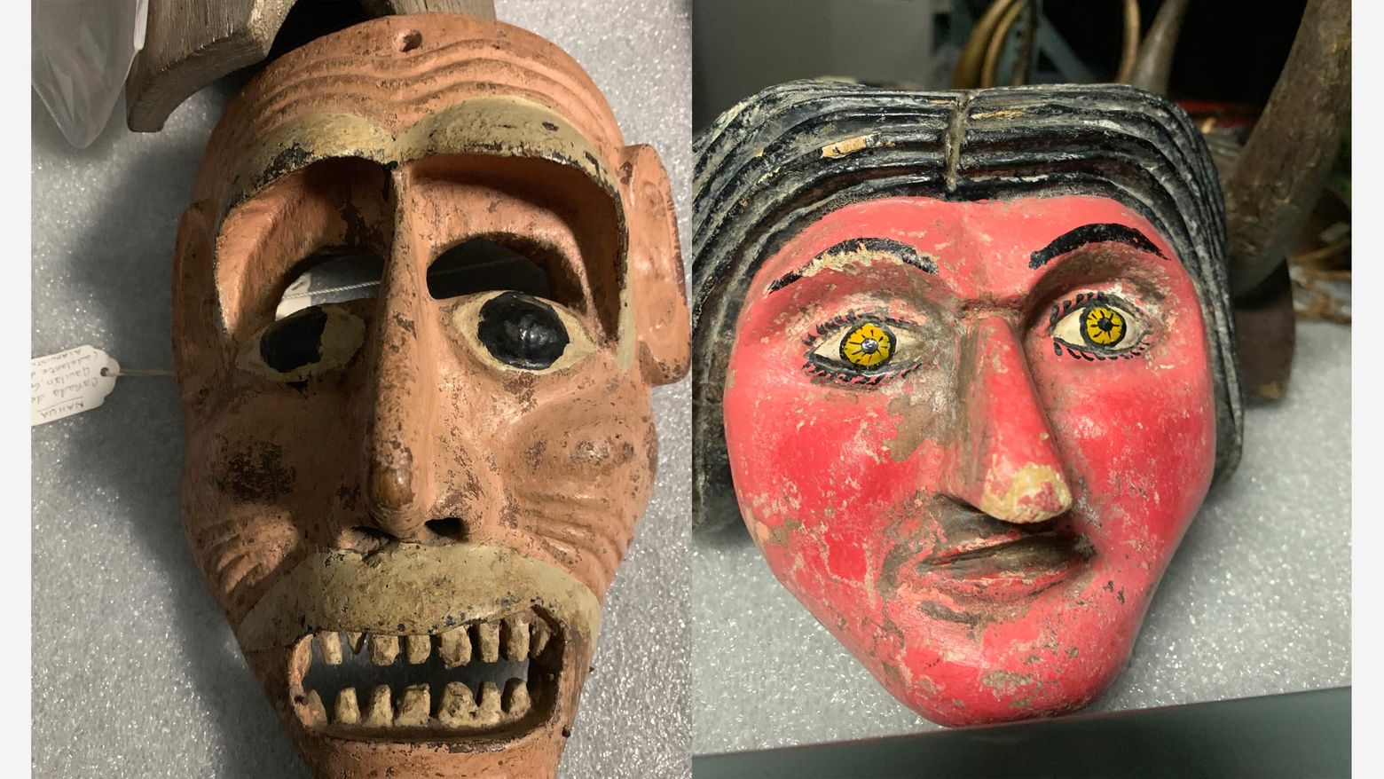 Two masks. On the left a brown mask with bared teeth and black eyes. On the right, a mask with a red face, black hair and yellow eyes.