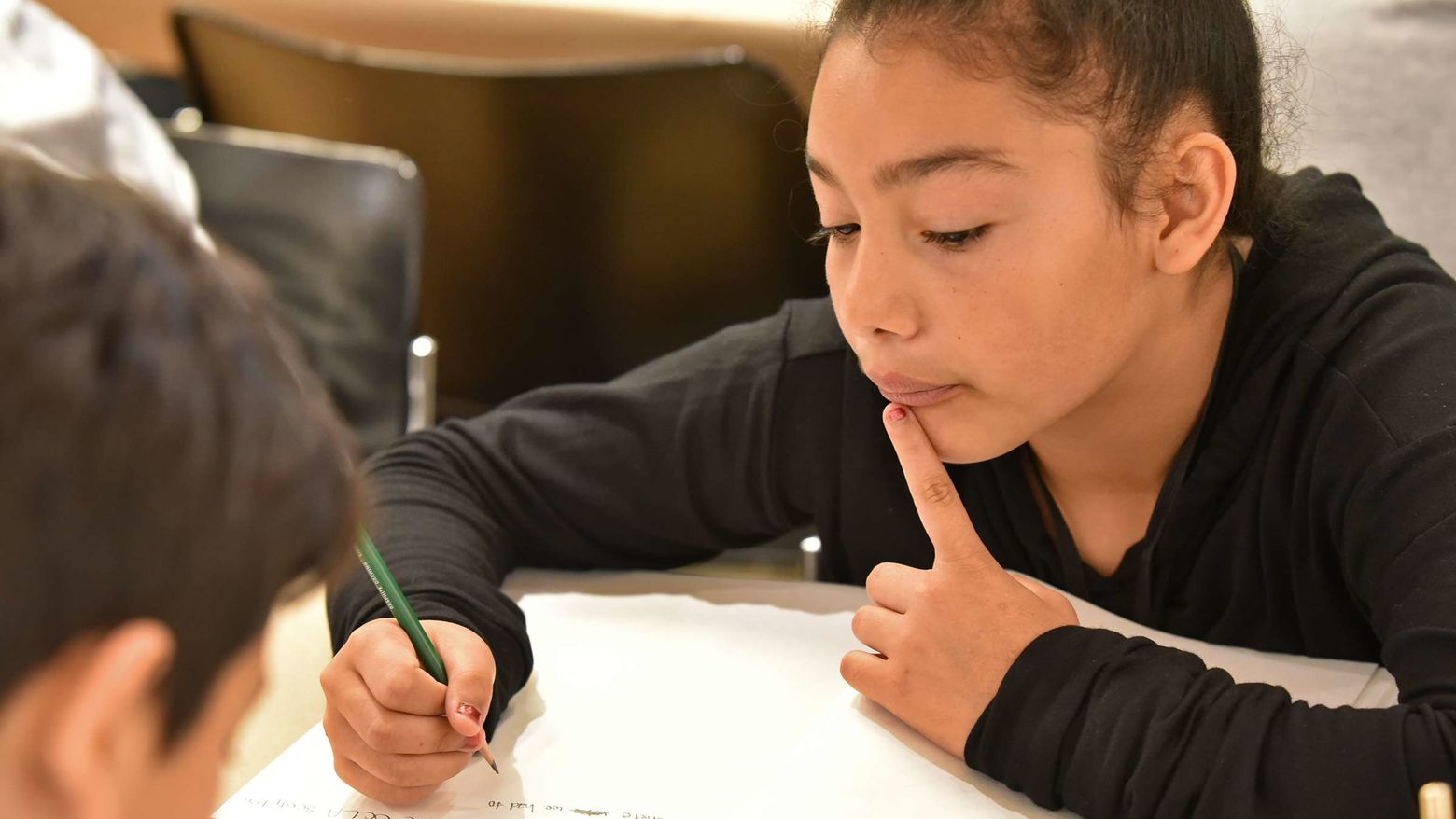 Child writing in a notebook.