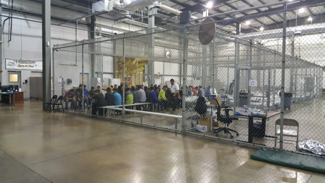 Detainees in a fenced in area inside a detention facility in McAllen, Texas.