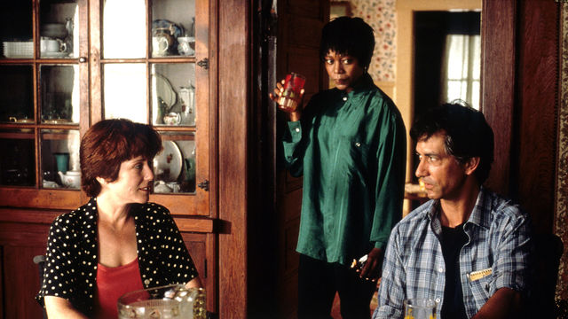 Still from the film Passion Fish (1992) showing a three people talking in a kitchen