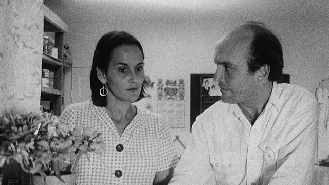 Still from the film The Whole Shootin' Match (1978) showing a man and a woman looking at each other with concern