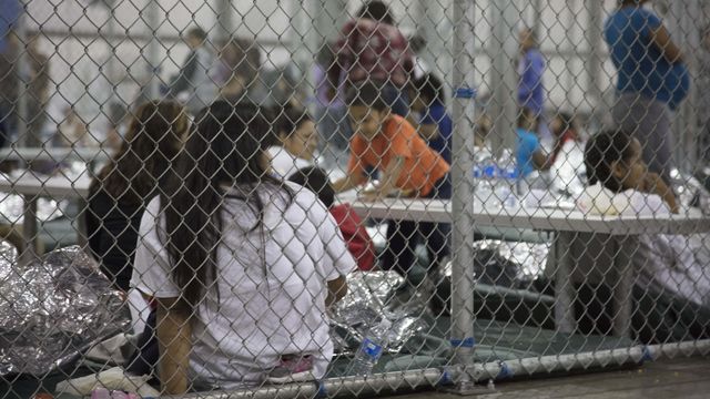 Women detained in a fenced in area at the Central Processing Center in McAllen, Texas, Sunday, June 17, 2018.