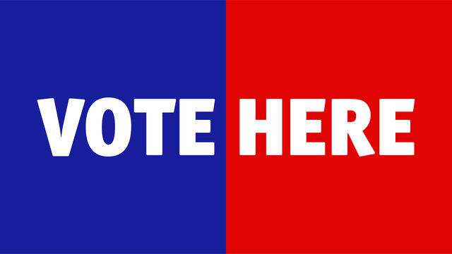 the words "VOTE HERE" appear across a background that is blue on the ledt half and red on the right half.