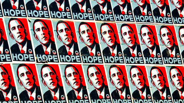 A wall covered in posters for President Obama