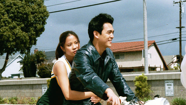 Still from the film Better Luck Tomorrow (2003) showing a young Asian American couple riding a motorcycle